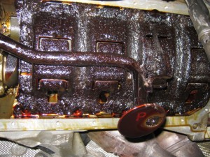 The engine sump (bottom), covered in carbonised oil