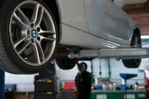 The bottom of a BMW car while elevated in a workshop