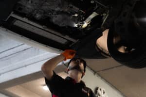 Pace Auto Werks mechanic investigating under a car