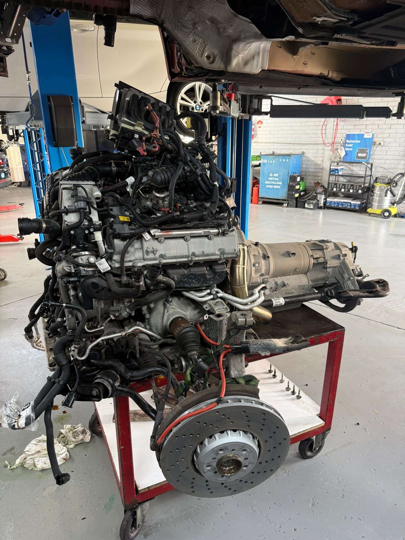 BMW X5M S63 engine and transmission removed as a unit on a workshop trolley at Pace Auto Werks