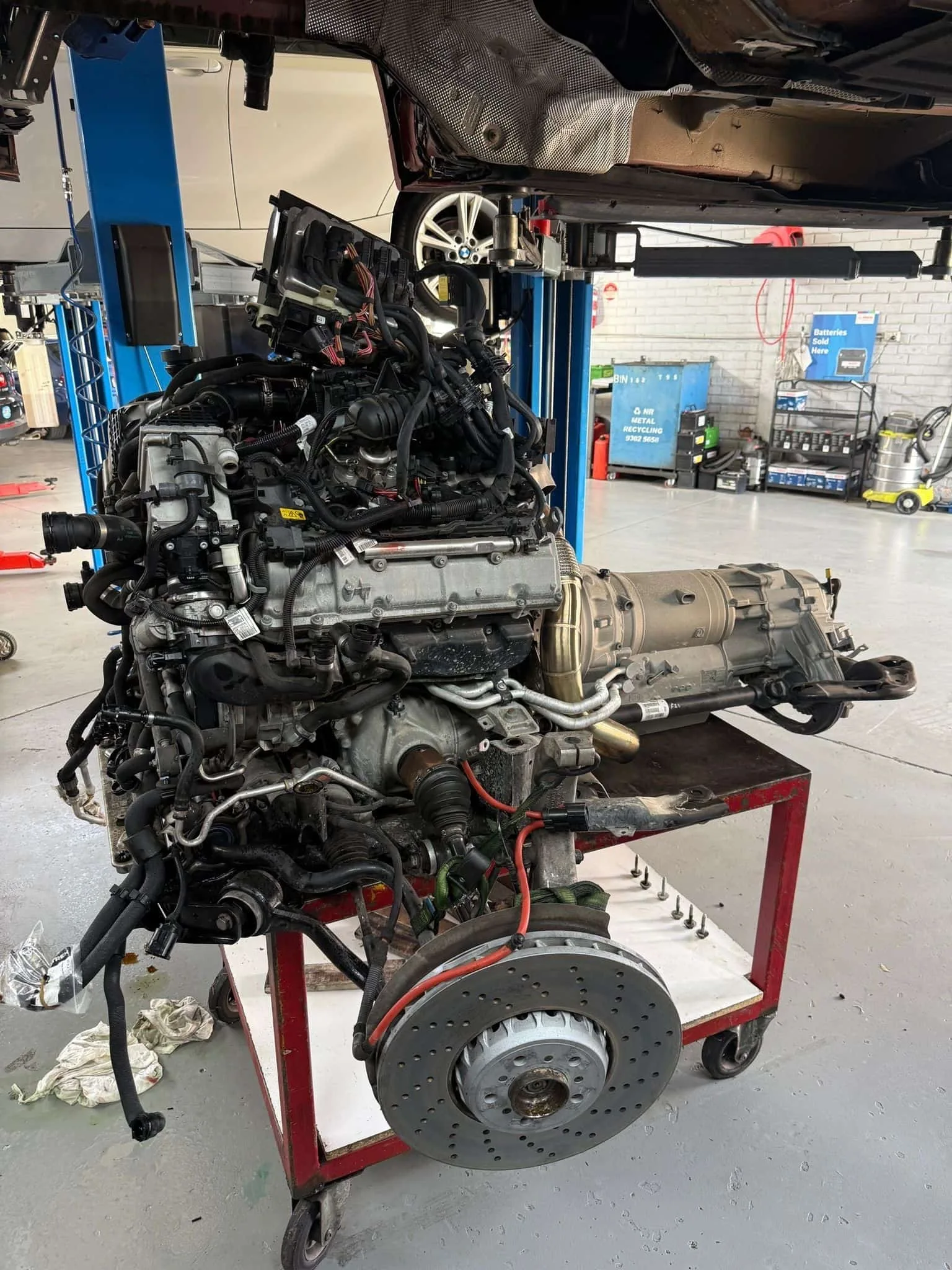 BMW X5M S63 engine and transmission removed as a unit on a workshop trolley at Pace Auto Werks