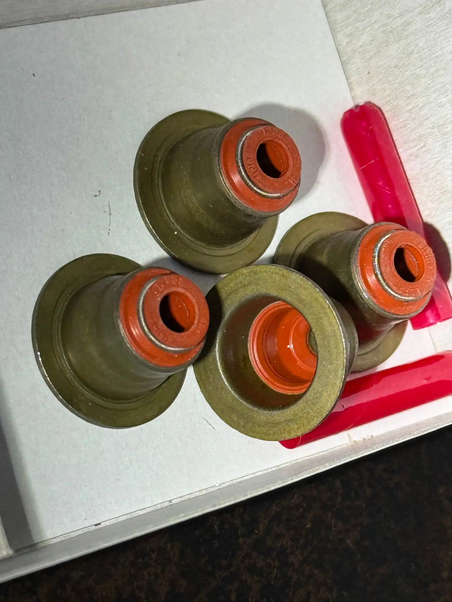 New replacement valve stem seals ready for installation in a 2017 BMW X5M S63 engine